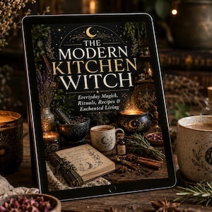 May include: A digital tablet displaying the book cover titled The Modern Kitchen Witch: Everyday Magick, Rituals, Recipes & Enchanted Living. The cover features a dark background with a crescent moon, a mortar and pestle, a cauldron, and a book.