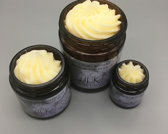 May include: Three glass jars of whipped body butter, each with a different amount of product. The jars are labeled "Plumeria Organic Whipped Body Butter" and "Nourishes and Softens Skin of All Types".