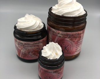 May include: Three glass jars of whipped body butter with a white, fluffy texture. The jars are labeled "Organic Bohemian Sandalwood Whipped Body Butter" and "Nourishes and Softens Skin of All Types".