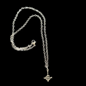 May include: Silver chain necklace with a silver pendant featuring the Ghostbusters logo.
