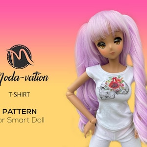 May include: A white t-shirt with a floral skull graphic for a Smart Doll. The t-shirt has a round neckline and short sleeves. The doll has long, wavy, lavender hair.