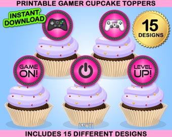 May include: Printable gamer cupcake toppers with a gaming theme. Each cupcake has a pink circle with a black design, such as a game controller or the words "Game On!" and "Level Up!". The image includes the text "Instant Download" and "Includes 15 Different Designs".