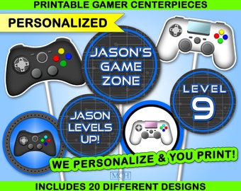 May include: Printable gamer themed centerpieces for a party. The centerpieces feature a blue and black color scheme with a video game controller design. The text on the centerpieces reads "Jason's Game Zone", "Jason Levels Up!" and "Level 9".