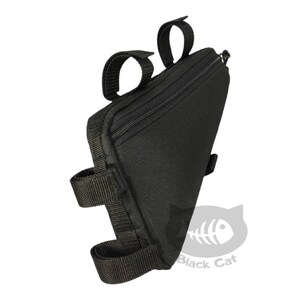 May include: A black triangular bicycle frame bag featuring a zippered main compartment, multiple adjustable hook-and-loop fastener straps for mounting, and a small logo graphic in the corner displaying a fish skeleton and the text Black Cat.