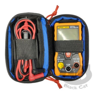 May include: An orange and black digital multimeter with a black carrying case. The multimeter has a screen and several input ports. The case also holds red and black test leads. The text "ANENG V01A DIGITAL MULTIMETER" is visible.