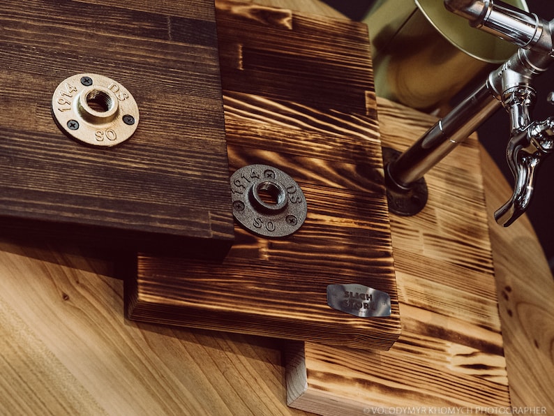 Three versions of the wooden dispenser stand in different colors