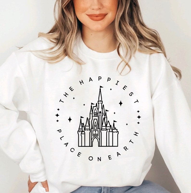 May include: White sweatshirt with a black outline of Cinderella's castle and the text "The Happiest Place on Earth" in a circle around it.