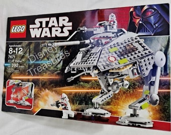 May include: A Lego Star Wars AT-AP Walker set with 392 pieces. The set features a gray and white walker with a red and white cockpit. The walker has four legs and a rotating cannon. The set also includes two minifigures: a clone trooper and a commander.