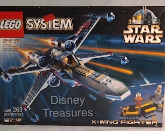 May include: A LEGO Star Wars X-Wing Fighter building set with 263 pieces. The box features a red, white, and blue X-Wing Fighter with a pilot in the cockpit. The box also features the text "LEGO SYSTEM", "STAR WARS", "Disney Treasures", and "X-WING FIGHTER".