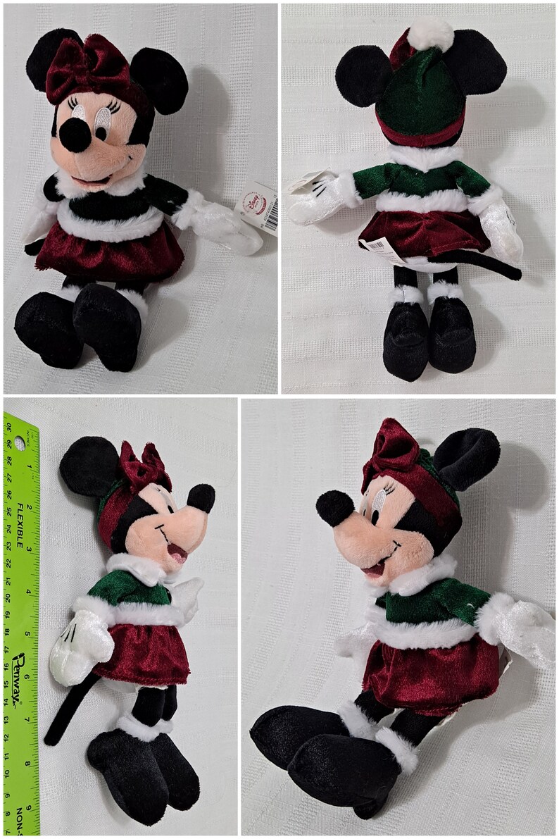 May include: A plush toy of Minnie Mouse dressed in a green and white Christmas outfit with a red velvet skirt and white fur trim. She is wearing a red velvet bow on her head and has a white fur trim around her neck.
