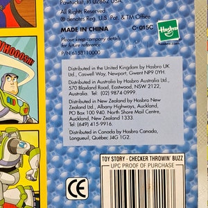 May include: Toy Story Checker Throwin' Buzz game packaging with a blue background and a UPC barcode. The packaging features a cartoon image of Buzz Lightyear in a yellow and green spacesuit. The text "Toy Story - Checker Throwin' Buzz" and "UPC Proof of Purchase" is printed on the packaging.
