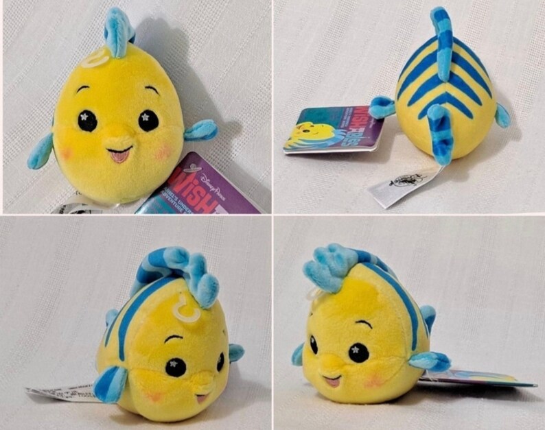 May include: Yellow and blue plush toy of a fish with a smiling face and a blue fin. The toy is about 5 inches tall and has a tag that says "Disney Parks Wish Upon A Star Adventure".