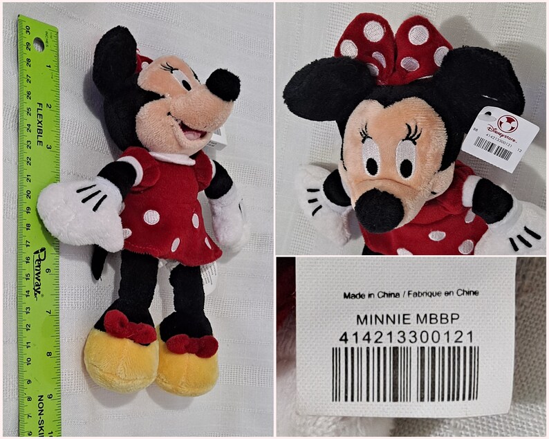 May include: A red and white polka dot Minnie Mouse plush toy with a black bow. The toy is approximately 25 cm tall and has a tag that says "Minnie MBBP" and "414213300121".