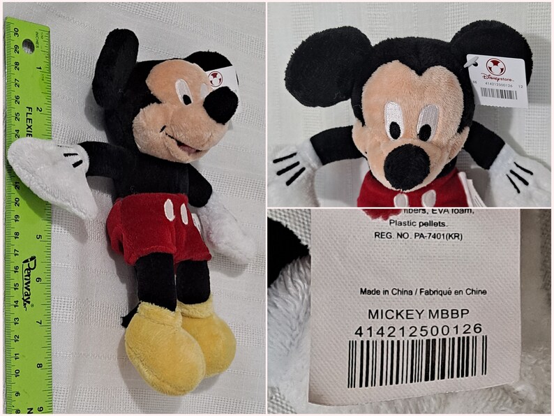 May include: A black and red Mickey Mouse plush toy with yellow shoes. The toy is approximately 10 inches tall and has a white tag attached to its right ear. The tag features the Disney logo and the text "MICKEY MBBP 414212500126".