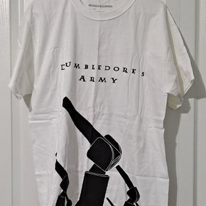 May include: White t-shirt with a black graphic of a raised fist and the text "Dumbledore's Army".