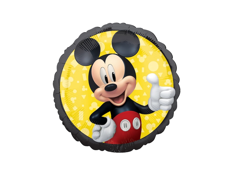 May include: A round foil balloon featuring a graphic of Mickey Mouse giving a thumbs up. The character wears red shorts with white buttons and white gloves. The background is a bright yellow circle with a pattern of small geometric shapes.