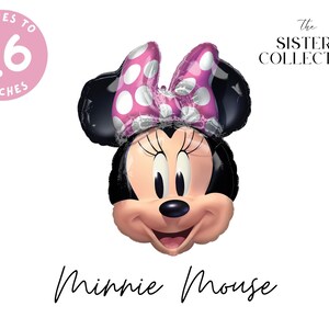 May include: A foil balloon shaped like the head of Minnie Mouse, featuring black ears, a pink bow with white polka dots, and a smiling face. The text "INFLATES TO 26 INCHES" appears in a pink circle, with "THE SISTERS COLLECTIVE" and "Minnie Mouse" text.