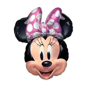 May include: A foil balloon shaped like the head of a cartoon mouse with black ears, a pink bow featuring white polka dots, long eyelashes, a small black nose, and a smiling mouth with a light pink face and a dark pink tongue.