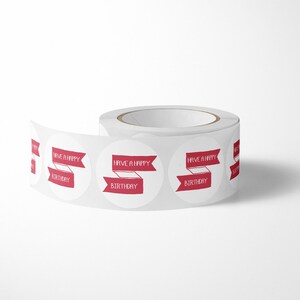 May include: A roll of white circular adhesive stickers featuring a red banner graphic with the text HAVE A HAPPY BIRTHDAY printed in white. The stickers are arranged in a continuous line on a backing paper roll, showing multiple repeating labels.