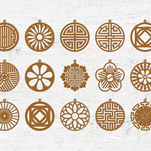 May include: Set of 16 brown laser cut ornaments with geometric and floral designs. The ornaments are circular and have a hole at the top for hanging.