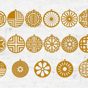 May include: Set of 18 gold-colored laser cut ornaments featuring geometric and floral designs. The ornaments are circular and have intricate patterns.