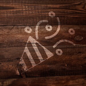 May include: A white graphic of a party popper with confetti circles and curved lines printed on a dark brown wooden surface with visible horizontal grain patterns and natural wood knots throughout the texture of the planks.