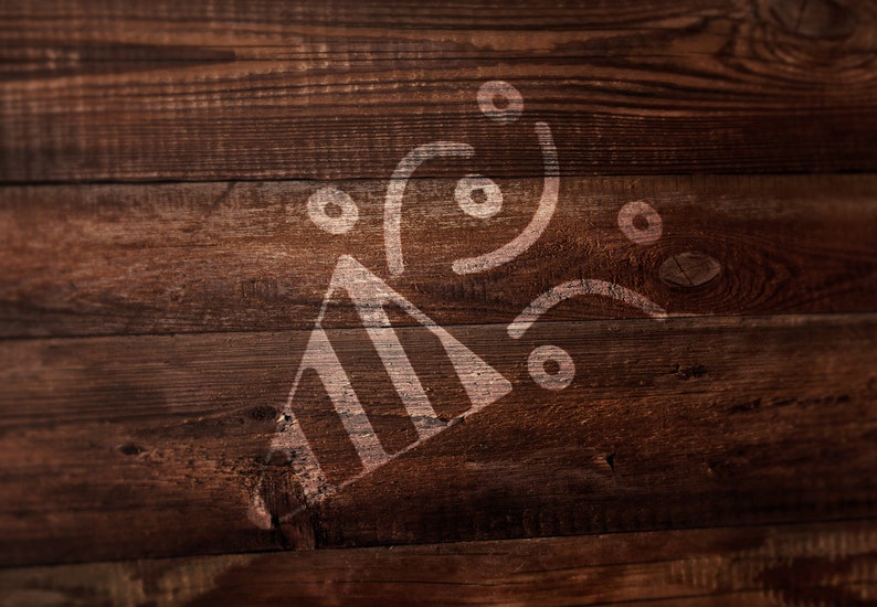 May include: A white graphic of a party popper with confetti circles and curved lines printed on a dark brown wooden surface with visible horizontal grain patterns and natural wood knots throughout the texture of the planks.