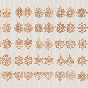May include: A collection of laser-cut earrings in various floral and geometric designs. The earrings are made of a warm, copper-colored material and are displayed on a neutral, textured background. Styles include teardrops, hearts, and starbursts.