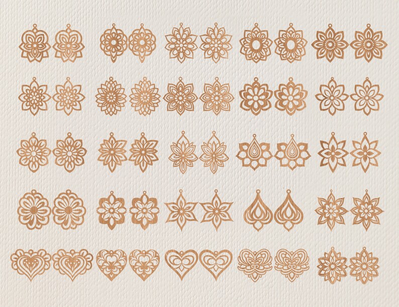 May include: A collection of laser-cut earrings in various floral and geometric designs. The earrings are made of a warm, copper-colored material and are displayed on a neutral, textured background. Styles include teardrops, hearts, and starbursts.