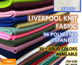 May include: A stack of colorful Liverpool knit fabric samples. The image displays a variety of solid colors, including black, green, pink, blue, and red. The fabric is 56 inches wide and made of 96% polyester and 4% spandex. The image also includes the text "Liverpool Knit Fabric".