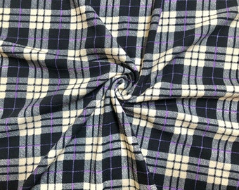 May include: Black and cream plaid fabric with a purple stripe. The fabric is folded and textured.