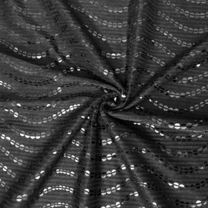 May include: Black fabric with a wavy pattern of silver sequins.