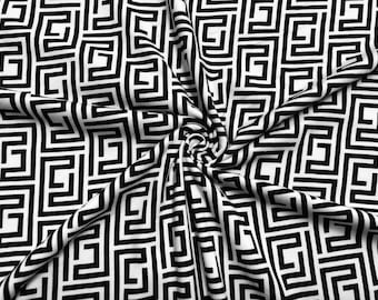 May include: Black and white fabric with a geometric pattern of interlocking squares and rectangles.