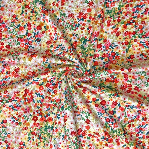 Tissu tricoté ivoire confettis fleurs sauvages DTY par mètre