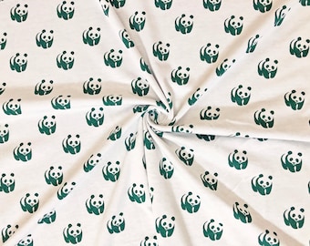 May include: White fabric with a repeating pattern of green panda bear illustrations. The pandas are depicted in a simple, stylized design, creating a playful and whimsical aesthetic. The fabric is likely cotton or a similar material.