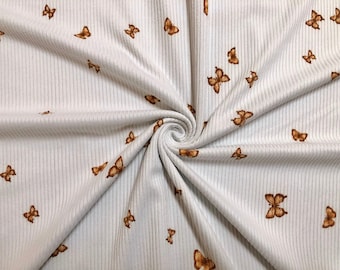 Ivoor/amberkleurige ribgebreide stof met vlinderprint, mix van stretchrayon op maat gesneden
