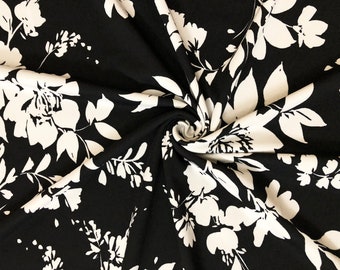 Svartvitt blommigt silhuett Techno Crepe stickat tyg, metervara