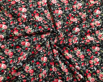 Tessuto a maglia spazzolata con motivo floreale a piccole rose nere/rosse, tagliato su misura.