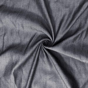 May include: Close-up of gray fabric with a spiral pattern in the center. The fabric has a textured appearance with visible folds and creases. The color is a solid, medium gray.