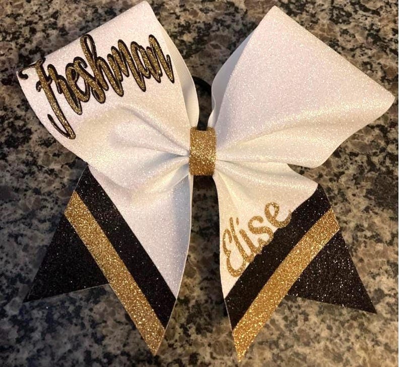Cheerleading bow with class on upper loop. "Freshman "on upper loop. Black and Gold custom cheerleading hair accessory.