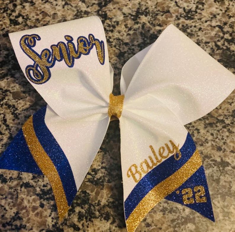 Full glitter white Senior Night Bow with royal blue and gold accent colors.