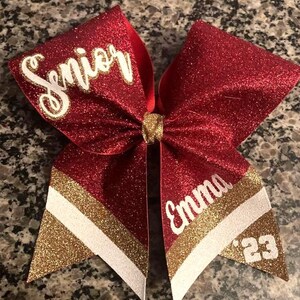 Senior cheer bow. Red full glitter bow with gold and white accent colors.