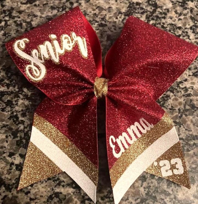Senior cheer bow. Red full glitter bow with gold and white accent colors.