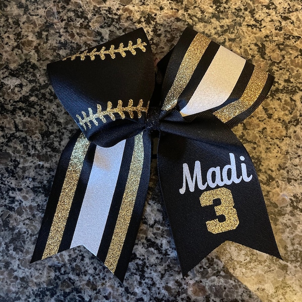 Softball bow / cheer bow with softball laces and number / your team colors on bow /baseball bow / black and gold softball bow shown.