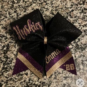 purple and black cheerleading bow