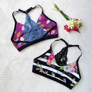 May include: Two black and white striped bralettes with floral patterns and black lace accents.