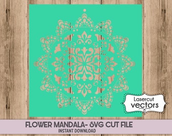May include: A teal green digital cut file of a flower mandala design. The design is intricate and detailed, with a circular shape and a floral pattern. The text "Lasercut vectors" is in a black box with a dashed border.