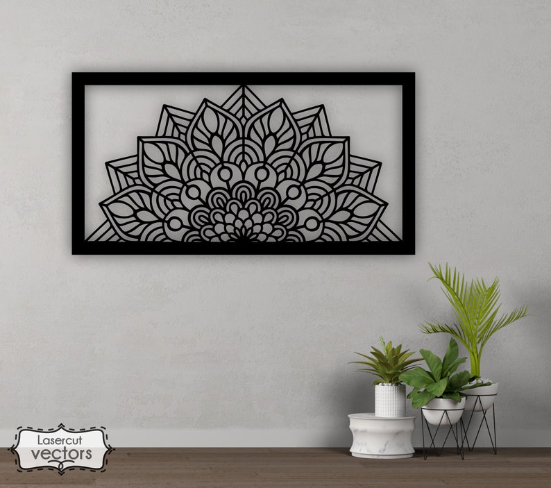 May include: Black metal wall decor with a large, intricate mandala design. The mandala is in the shape of a half circle and has a black frame.