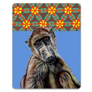 May include: A rectangular baboon-themed decorative item. The baboon is brown and grey with a curious expression, set against a blue background. The top portion features a repeating floral pattern in red, yellow, and green.