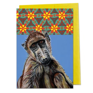 May include: A close-up of a baboon's face with brown fur against a blue background. The baboon has a serious expression and is looking directly at the viewer. The background is a blue colour with a pattern of red and yellow flowers.